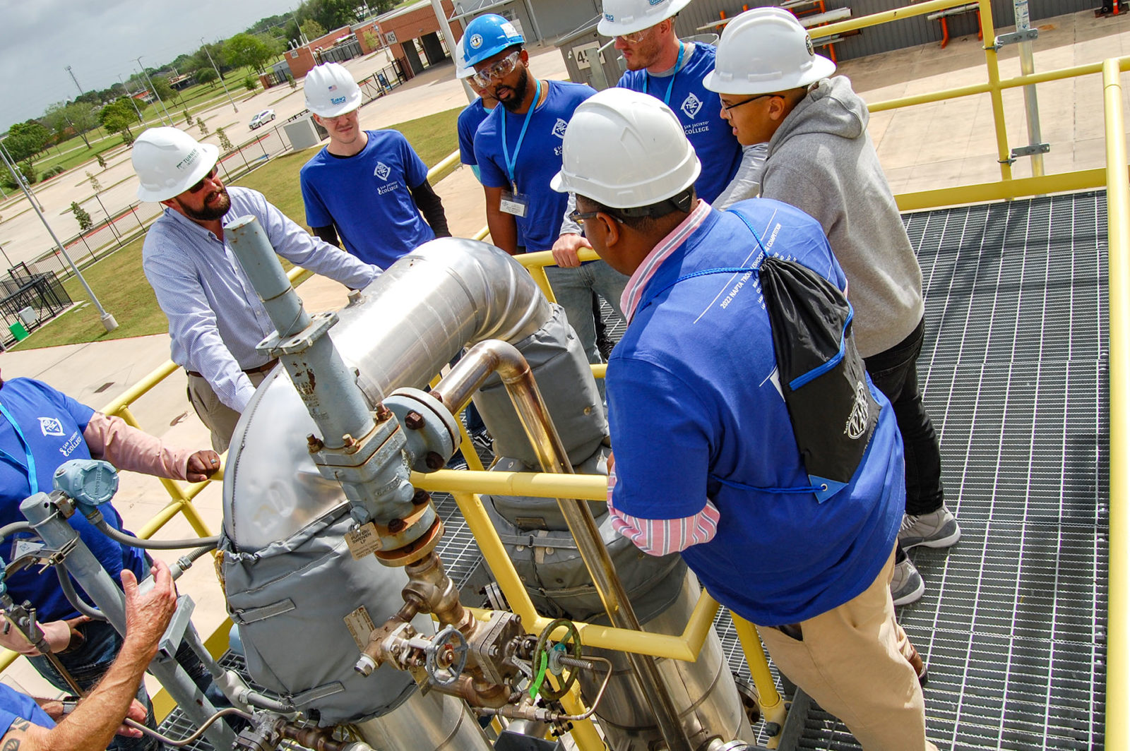 Workers around a pipe.