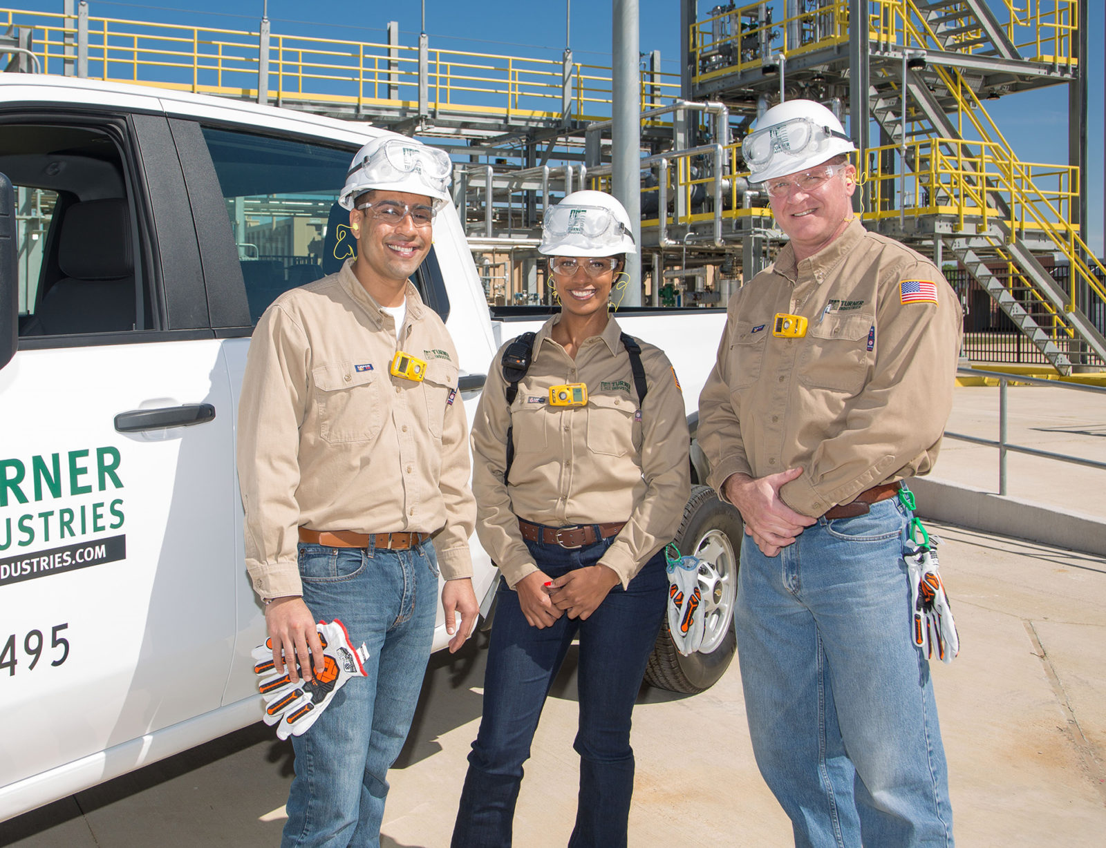 Three workers at a site.