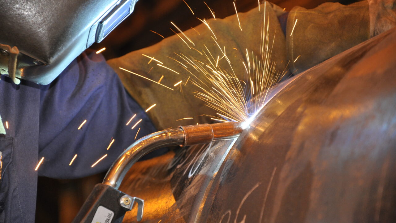 Industrial professional wearing mask while welding